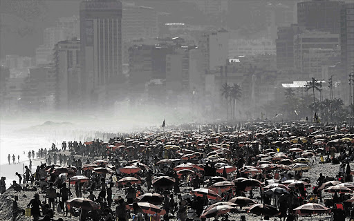 People at Ipanema beach in Rio de Janeiro. The world's population will reach seven billion at the end of the month, according to projections by the UN, and this will impact on the environment Picture: REUTERS