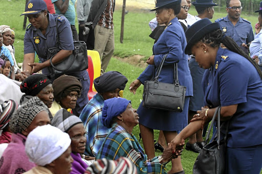 Family members are comforted by police officers.