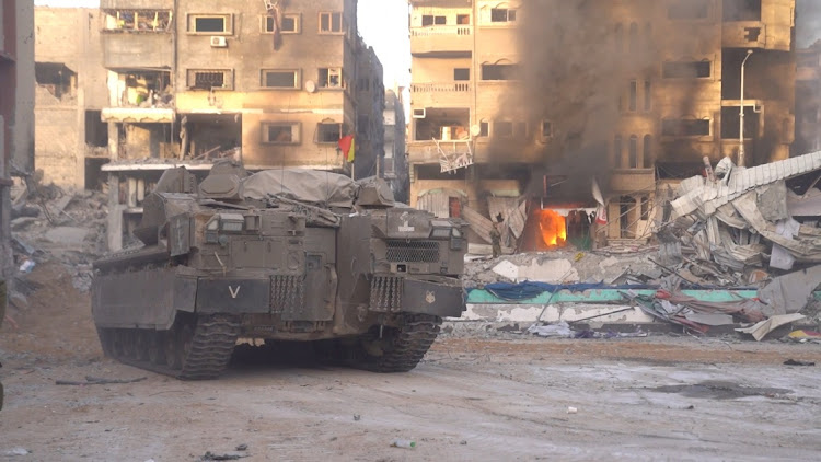 An Israeli military armoured vehicle operates amid the ongoing conflict between Israel and Hamas, at a location given as Al-Shati, Gaza, in this still image taken from video released November 14, 2023.