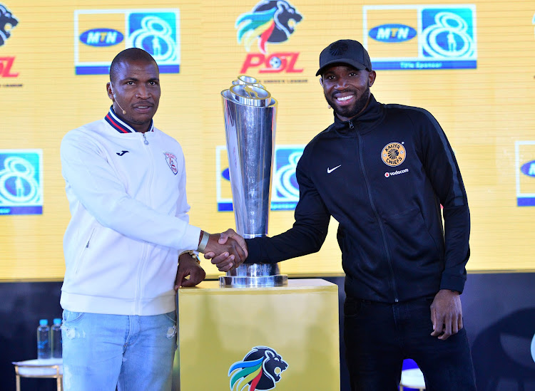 Kaizer Chiefs defender Ramahlwe Mphahlele (R) shakes hands with Free State Stars' Nedbank Cup winning captain Paulus Masehe (L) during the MTN8 launch at Johannesburg Park Station, Johannesburg on July 30 2018.