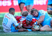 Good work from Manie Libbok of the Vodacom Bulls and Pierre Schoeman of the Vodacom Bulls to deny Lourens Erasmus of the Emirates Lions his try during the Super Rugby match between Emirates Lions and Vodacom Bulls at Emirates Airline Park on July 14, 2018 in Johannesburg, South Africa.