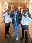 WBO bantamweight champion Zolani Tete, right, and trainer  Mhikiza Myekeni, left,  with    American trainer Floyd Mayweather snr in Russia, where Tete will defend his title on Sunday.