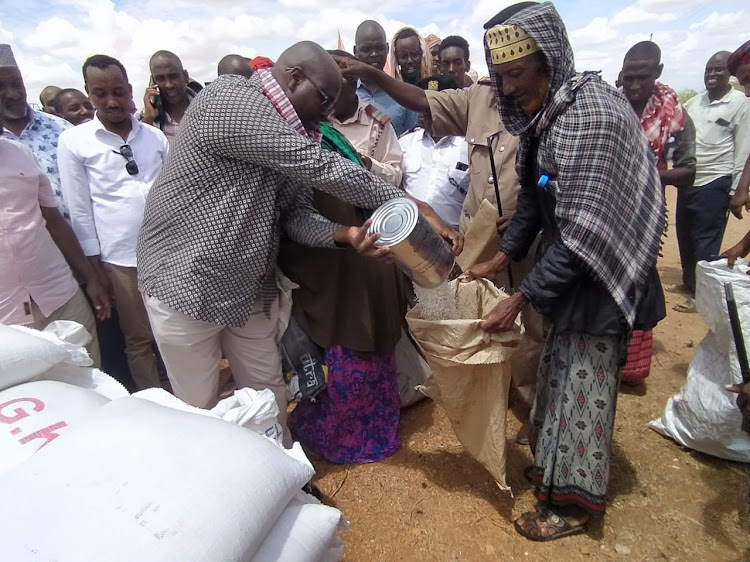 Arid and Semi-Arid Lands Principal secretary Idris Dokota leads a food distribution exercise to residents of Dukanotu in Tana River county.