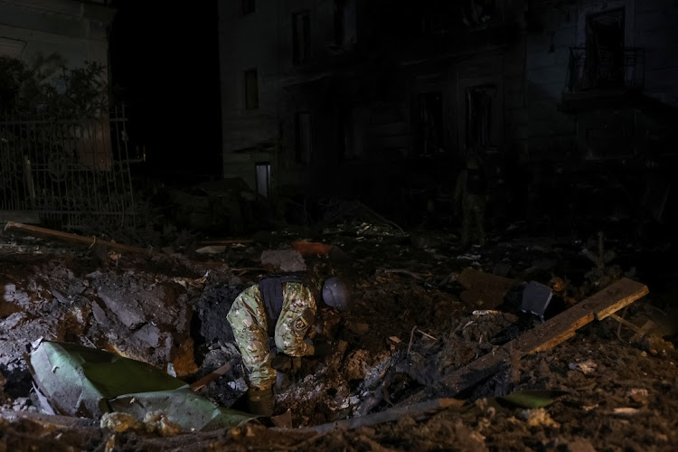 A bomb squad member works at a site near a residential building heavily damaged during a Russian missile attack, amid Russia's attack on Ukraine, in central Kharkiv, Ukraine January 24, 2024.