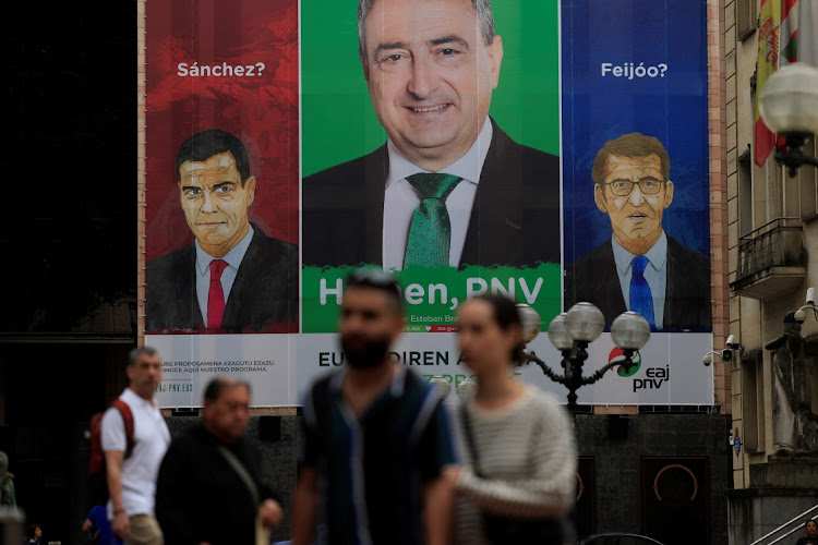 Spain's Socialist Party leader and Prime Minister Pedro Sanchez and opposition People's Party leader Alberto Nunez Feijoo are pictured alongside Basque Nationalist Party candidate Aitor Esteban on a poster in Bilbao, Spain, July 24 2023. Picture: REUTERS