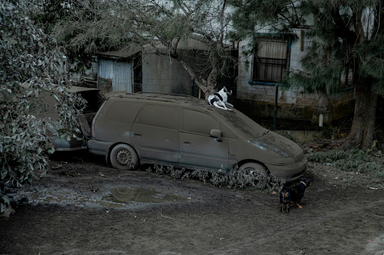 A car covered with ash is seen outside a house following volcanic eruption and Tsunami in Tongatapu, Tonga on January 16, 2022.