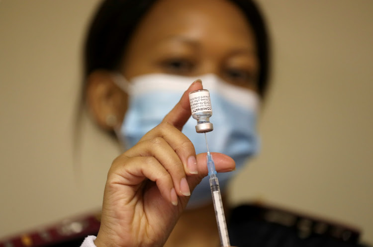 A health worker holds a vial of the Pfizer/BioNTech coronavirus disease (Covid-19) vaccine, at the Munsieville Care for the Aged Centre outside Johannesburg, South Africa.