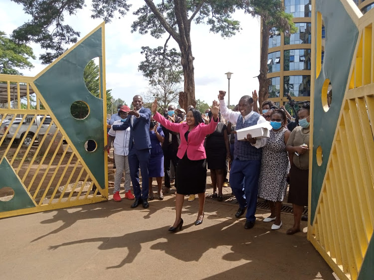 Rose Wachira leaves the county headquarter office at Kutus accompanied by her former county workmates after resigning from office.