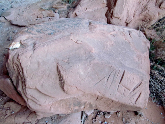 Sharpening grooves in a boulder