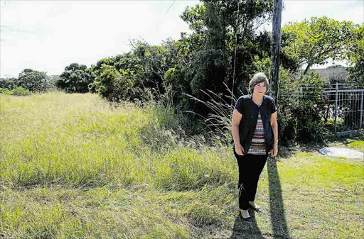 Quenera Drive resident Judy Lindsay, 70, has appealed to Eskom to clear the overgrown bush and fence the vacant land. Picture: ALAN EASON