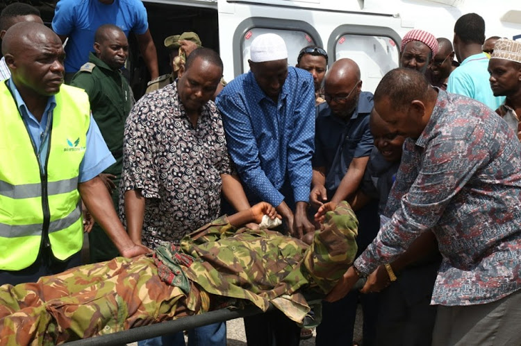 One of the AP police officers who was injured in the Konton IED attack in Wajir on June 15 is assisted by local leaders led by area Governor Mohamed Abdi to board an aircraft to Nairobi for specialized treatment.