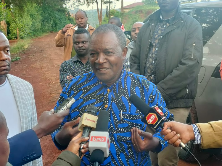 Treasury Cabinet Secretary Njuguna Ndung'u addressing journalists outside Gacharage Primary School polling centre on December 5, 2023.