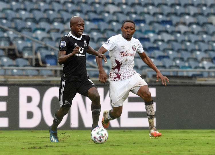 Tlakusani Mthethwa of Swallows FC challenges Ben Motshwari of Orlando Pirates.