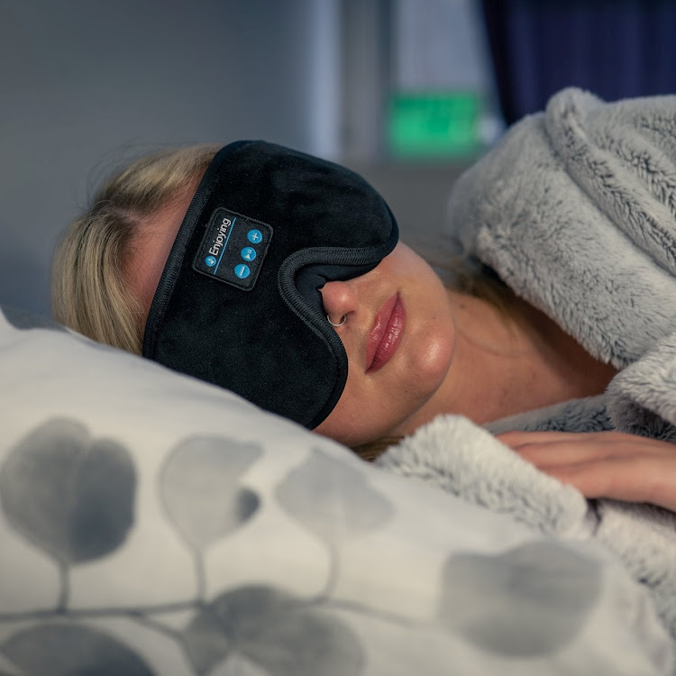 Here's a great secret weapon for a long-haul flight: a sleep mask with sewn-in bluetooth headphones.