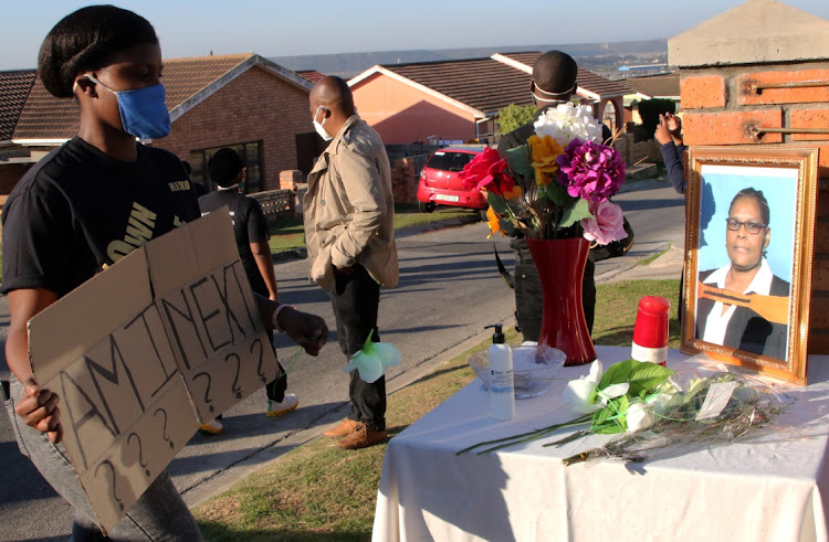 A group of KwaMagxaki Dwellers Forum members hold a walk/drive-past to pay their respects to the family of two elderly women who were shot dead at their home during a robbery last week