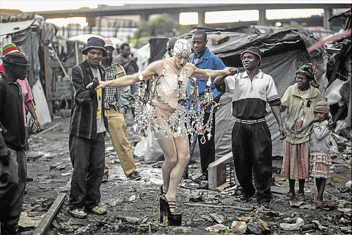 Steven Cohen performs 'Chandelier' at a squatter camp behind the Market Theatre in Newtown, Johannesburg