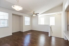 Open concept living areas with wood inspired flooring throughout