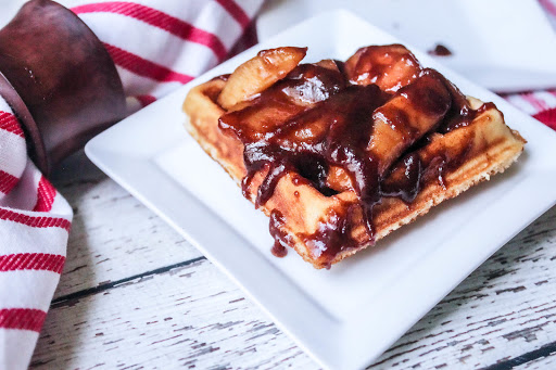 Fried Apples spooned over waffles.