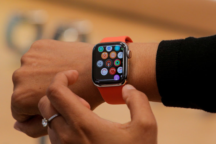 An Apple Store employee shows the new Series 5 Apple Watch during the preview of the redesigned and reimagined Apple Fifth Avenue store in New York,