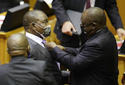 Finance minister Enoch Godongwana is having his tie fixed by President Cyril Ramaphosa ahead of his first medium term budget speech at parliament, Cape Town on Thursday.