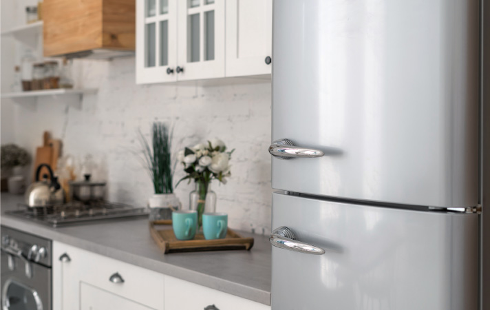 A galley kitchen with a new retro-style fridge