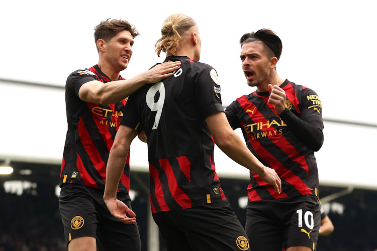 Manchester City's John Stones, Erling Haaland and Jack Grealish celebrate during their match against Fulham