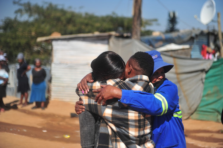 The emotional family of Vusi Seabi after he and three others were burnt to death in Zandspruit. Seabi was part of a group of nine men who were attacked.