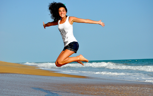 Girl jumping on the beach