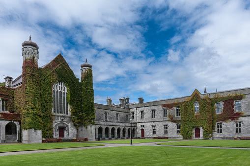 A large brick building with a lawn in front of it

Description automatically generated with low confidence