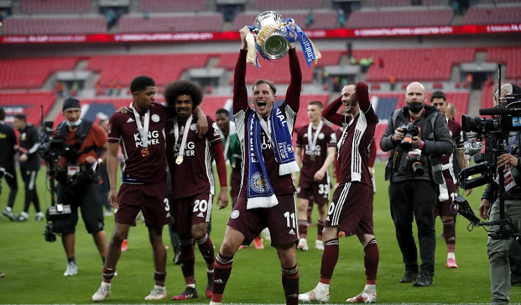 Wes Morgan and Kasper Schmeichel of Leicester City lift the Emirates FA Cup Trophy, following their team's victory in The Emirates FA Cup Final match between Chelsea and Leicester City at Wembley Stadium on May 15, 2021 in London, England.