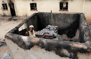 November 09, 2016.  Joyce   Mphethi , who carried her ill 60-year-old-father out of their home when they came under attack at GaMphethi in Limpopo, inspects the damage to their property.Photo: SANDILE NDLOVU © Sowetan