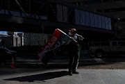 Vendor Eddie Tyler displays his Black Lives Matter flags outside of the Hennepin County Government Center in Minneapolis, Minnesota, US, on March 11 2021, as jury selection continues in the trial of former Minneapolis police officer Derek Chauvin, on murder charges over the death of George Floyd.