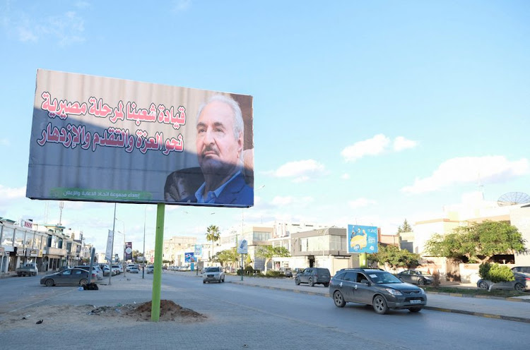 A billboard with an image of Libya's eastern commander and presidential candidate Khalifa Haftar is pictured by a roadside in Benghazi, Libya December 22, 2021