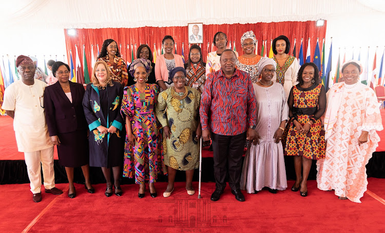 President Uhuru Kenyatta posing for a photo with other officials during the receiving of the African Gender Award at Statehouse on Tuesday, June 14, 2022.