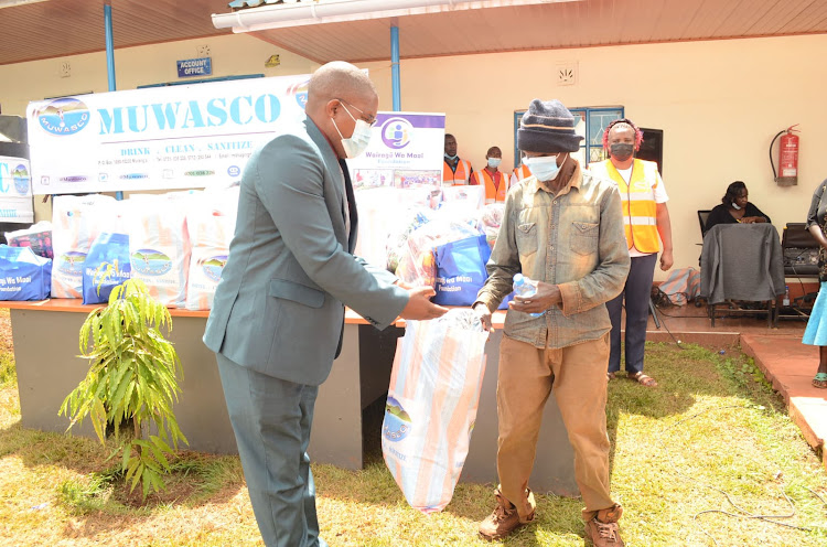 Muwasco MD Daniel Ng'ang'a donating foodstuffs to needy families at the firm's offices on Wednesday.