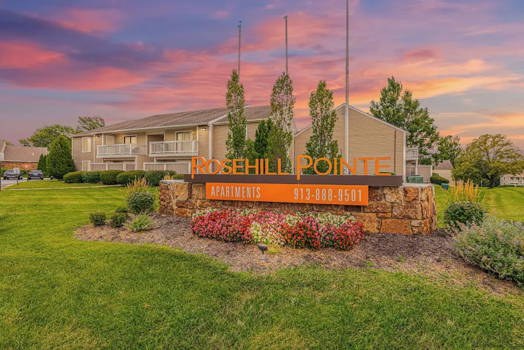 Rosehill Pointe's community sign with landscaping and apartment buildings in the background