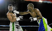 Nkululeko Mhlongo  throws a punch at  Emanny Kalombo during  their WBF Intercontinental junior middleweight fight  at Edenvale Community Centre. / Veli Nhlapo