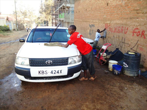 Youth at work at a car wash.