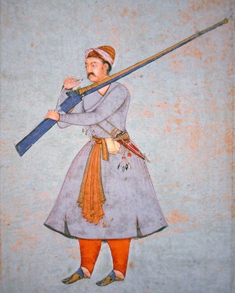 Man wearing a traditional uniform holding a long barreled rifle. Details in text.