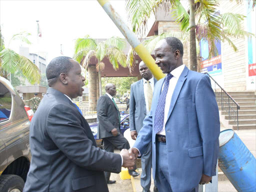 Acting Interior CS Fred Matiang'i is welcomed by Director General Immigration department Gordon Kihalangwa for the launch of e-Passport . photo/PATRICK VIDIJA