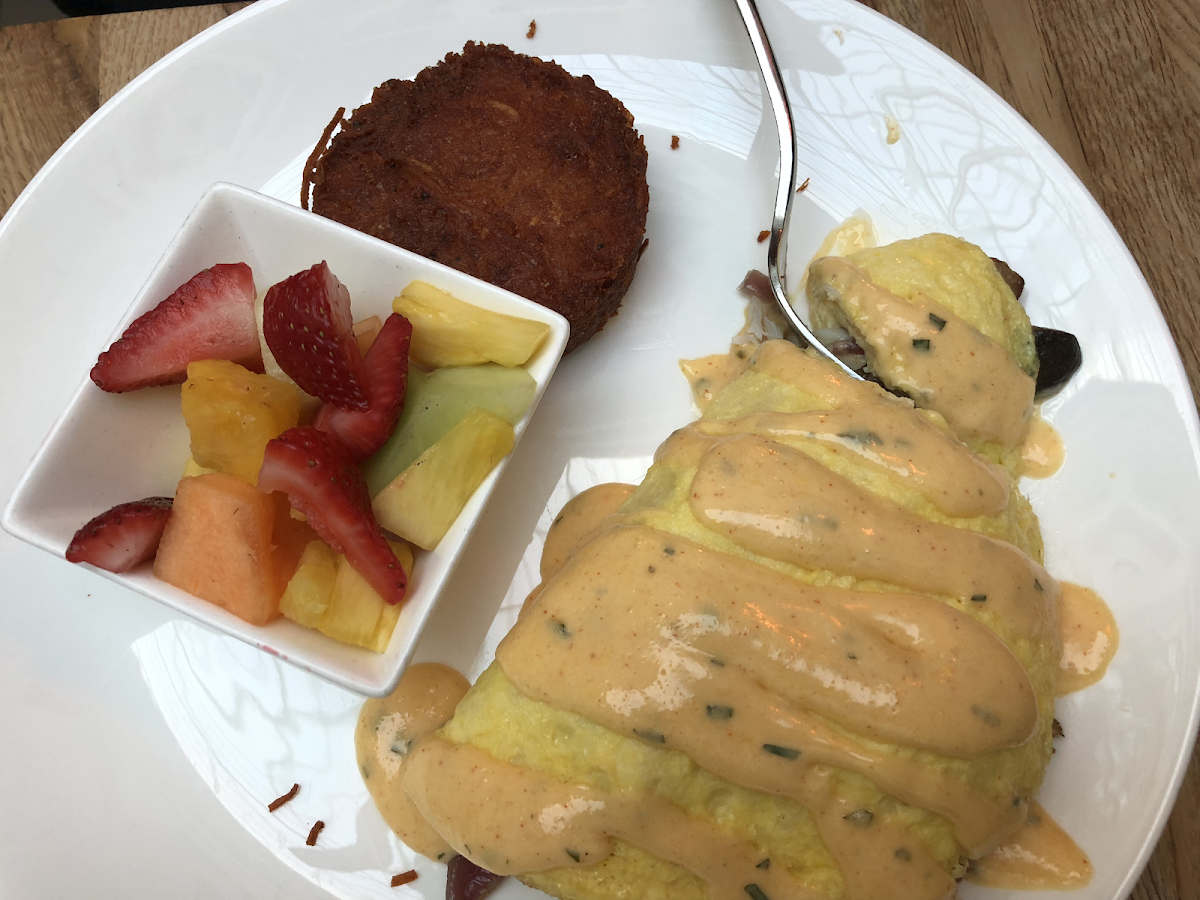 Crab omelette with hollandaise sauce. Server subbed toast with fruit to make the breakfast gluten free. Deep fried potatoes were fried in a shared fryer.