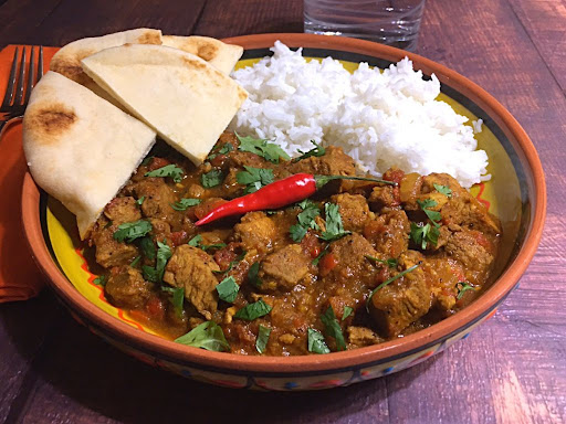 A delicious spicy Pork Vindaloo served with naan bread and basmati rice.