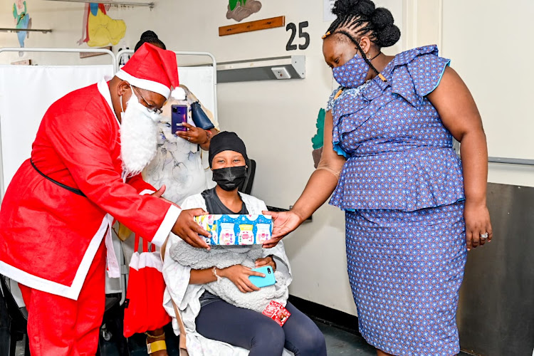 KZN health MEC Nomagugu Simelane hands over a gift to a mother who delivered a baby on Christmas Day at Addington hospital.