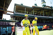 Australian openers David Warner and Aaron Finch walk onto the field to bat after Cricket Australia announced no public will be admitted to venues for the three match series during game one of the One Day International series between Australia and New Zealand at Sydney Cricket Ground on March 13, 2020 in Sydney, Australia. 