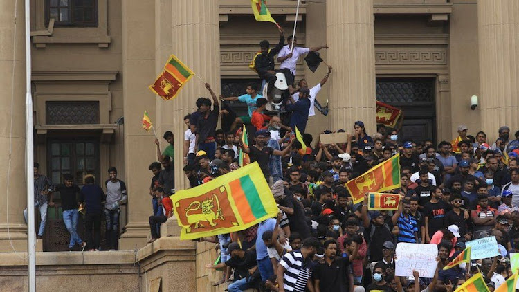 Protesters made their way into the presidential palace, chanting slogans and waving the national flag on Saturday, June 9, 2022.