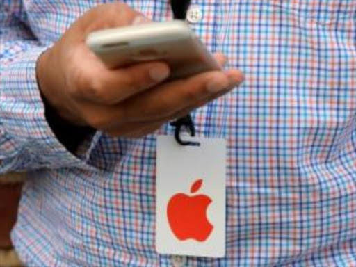 A man uses his iPhone before a preview event at the new Apple Store Williamsburg in Brooklyn, New York, U.S., July 28, 2016./REUTERS