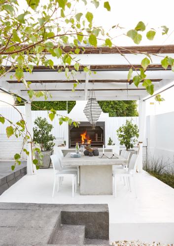 This formerly forgotten urban backyard was transformed into a sun-splashed, terraced garden – and outdoor cooking and dining area – that has since been the setting for many a party on weekend afternoons.