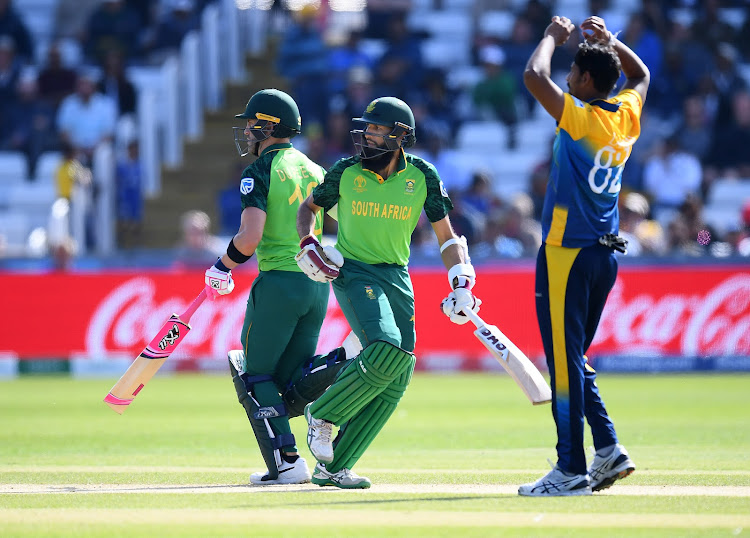 Hashim Amla and Faf du Plessis of South Africa run as Suranga Lakmal of Sri Lanka looks on during the Group Stage match of the ICC Cricket World Cup 2019 between Sri Lanka and South Africa at Emirates Riverside in Chester-le-Street, England on June 28 2019.