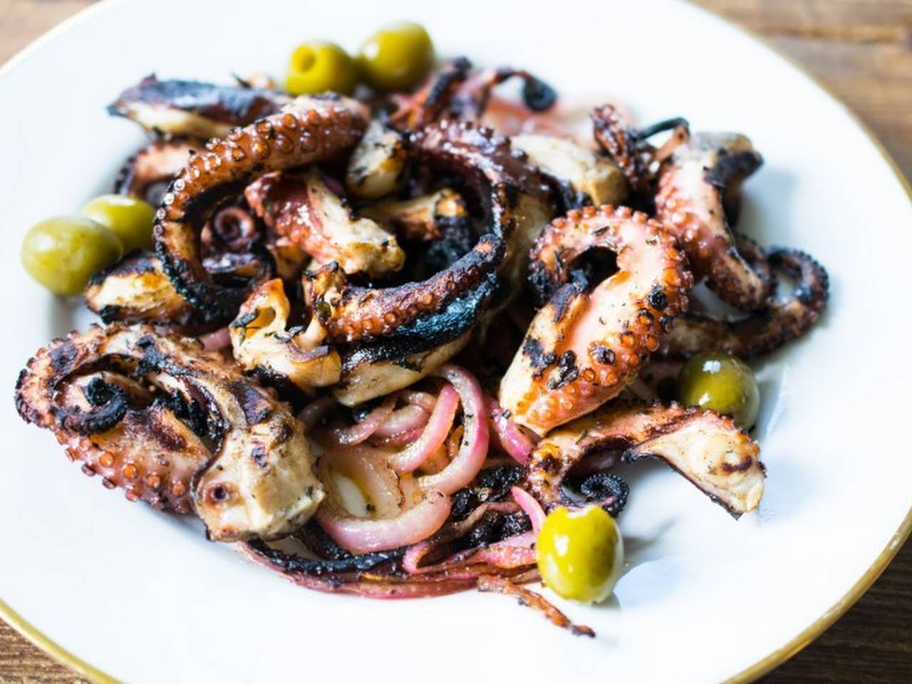 Grilled octopus over squid ink pasta and tomato garlic sauce - Viktoria's  Table