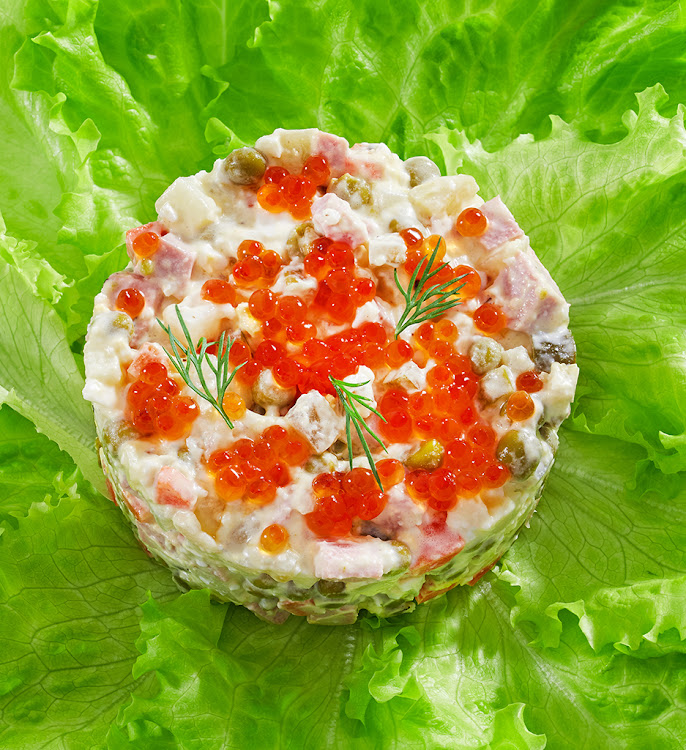 Traditional Russian potato salad with caviar and dill